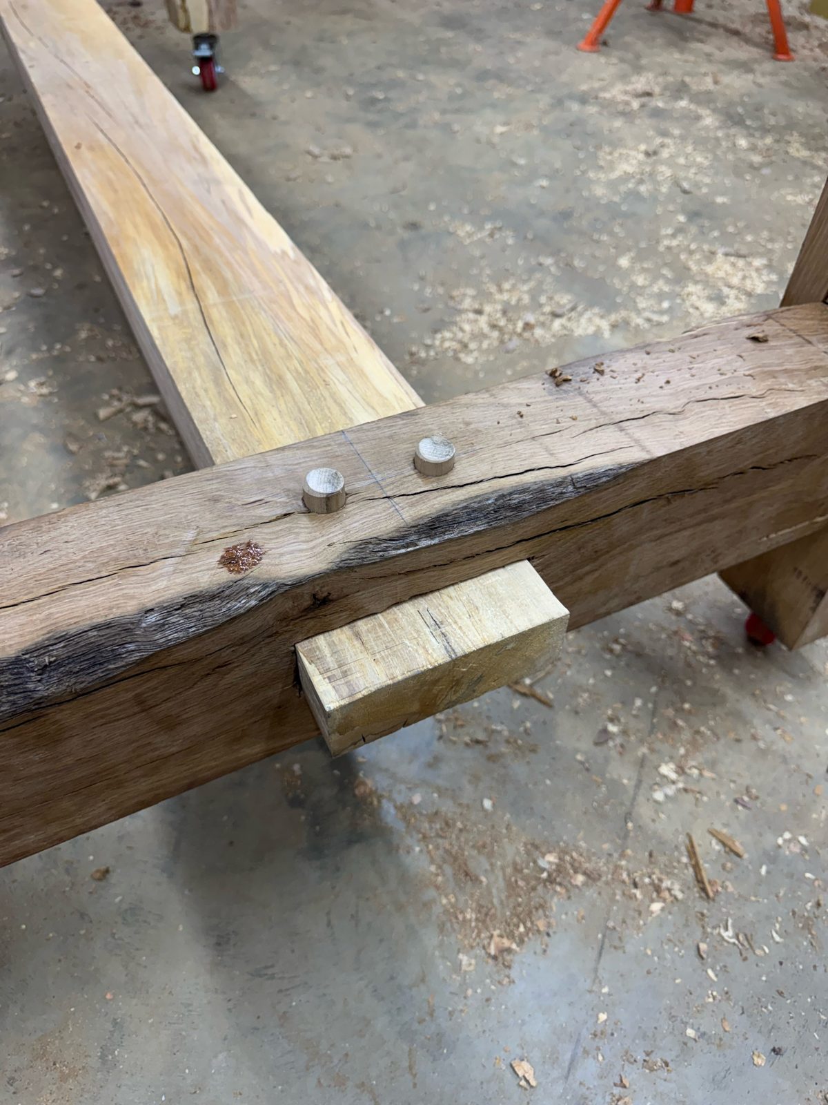 Close-up of a pegged mortise-and-tenon joint in oak timber